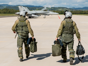 Pilots walk towards their CF-188 Hornet aircraft on the tarmac at Cerklje Air Force Base, Slovenia during Operation REASSURANCE on September 21, 2017.  PHOTO BY Sgt. Daren Kraus/Canadian Forces