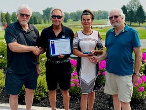 The Rotary Club of Grand Bend Community Service Award 2021 being presented to Mac Voisin and Marcela Bahar of the White Squirrel Golf Club by Ed Fluter, far left, and Peter Phillips, far right. Handout