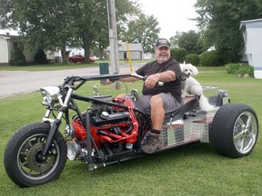 Exeter's Terry Haugh sits on the three-wheel, 360-horsepower trike he built from scratch over the past several months. Haugh, who typically travels to Florida every winter, said he came up with a project for himself to work on when he couldn't go south due to the pandemic. Hitching a ride with Haugh is his dog Hector. Scott Nixon