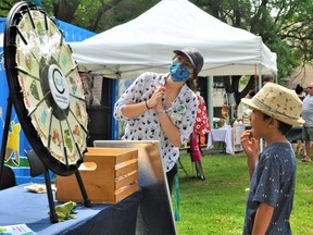 Communication and stewardship assistant for the Raisin Region Conservation Authority Janie Would discusses various ecological issues with an attentive Rémi St-Jean, during the first ever Eco Day hosted on Saturday August 7, 2021 in Cornwall, Ont. Francis Racine/Cornwall Standard-Freeholder/Postmedia Network