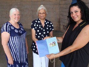 From left during Storytelling in the Park are Jane Macmillan, Usha Kapoor, Jane Macmillan and Yafa Goawily, with a book made by kids earlier this summer.Photo on Tuesday, August 10, 2021,  in Cornwall, Ont. Todd Hambleton/Cornwall Standard-Freeholder/Postmedia Network