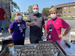 SDG Warden Al Armstrong enjoys some fries with Dundas Manor activity director Jennifer Hill (left) and administrator Susan Poirier (right). Handout/Cornwall Standard-Freeholder/Postmedia Network