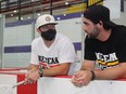 Professional lacrosse player Jacob Ruest (left), of Cornwall, and Jake Fox, two of the coaches with the Nepean Knights, chat at the team bench before a game on Thursday afternoon at the Survivor's Cup. Photo on Thursday, August 19, 2021, in Akwesasne. Todd Hambleton/Cornwall Standard-Freeholder/Postmedia Network