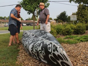Checking out the canoe in the east roundabout in Long Sault are donor and local resident/businessman Andre Pommier, SDG economic development manager Tara Kirkpatrick, and South Stormont Deputy Mayor Dave Smith. Photo on Friday, August 20, 2021, in Long Sault, Ont. Todd Hambleton/Cornwall Standard-Freeholder/Postmedia Network