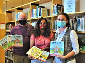 Pierre Dufour, the Cornwall Public Library's communications and programs co-ordinator and public service manager Rebecca Cameron surround author Denise Bourgeois-Vance on Thursday August 26, 2021 in Cornwall, Ont. Francis Racine/Cornwall Standard-Freeholder/Postmedia Network
