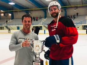 Team Pageau/Brodie captain T.J. Brodie, right, receives the championship trophy from Colin Roeszler of Athletes' Fuel Strength & Conditioning after winning the Athletes' Fuel Cup at Thames Campus Arena in Chatham, Ont., on Tuesday, Aug. 24, 2021. (Contributed Photo)