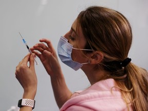 FILE PHOTO: A medical worker prepares to administer a vaccination against the coronavirus disease.