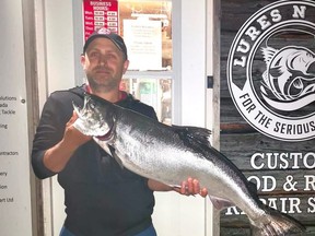 Nathaniel Clauser of Kawartha Lakes holds up his 21.72-lb chinook salmon, which won top prize at the Chantry Chinook Classic Salmon Derby. SUPPLIED