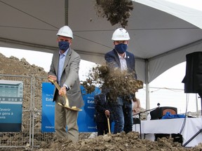 Dr. Michael Guerriere, (on left) president and chief executive officer of Extendicare, and Mayor Bryan Paterson break ground at Extendicare's future west end location in Kingston on Tuesday.