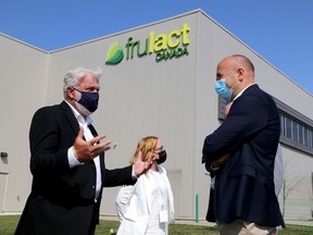 Kingston Deputy Mayor Wayne Hill, left, chats with Frulact COO Rosario Silva as KEDCO CEO Donna Gillespie looks on after the announcement of a $22.5 million expansion of the Kingston Frulact facility on Friday August 27, 2021.