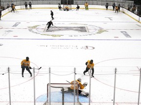 The Kingston Frontenacs are put through their paces at the Leon's Centre in Kingston by new coach Luca Caputi on Tuesday. It was the first time the Frontenacs had skated on home ice since March 2020.