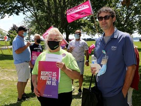 1974 president Barb DeRoche and Kingston General Hospital worker Rob Hamilton attend an information picket in Macdonald Park, across King Street from Kingston General Hospital, on Tuesday.