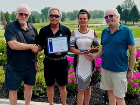 The Rotary Club of Grand Bend Community Service Award 2021 being presented to Mac Voisin and Marcela Bahar of the White Squirrel Golf Club by Ed Fluter, far left, and Peter Phillips, far right.