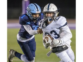 Lucas Vikings player Moaaz Moustafa grabs Catholic Central ball carrier Luke Ciapka during the WOSSAA senior football championship game at TD Stadium in London on Thursday Nov. 21, 2019. (Derek Ruttan/The London Free Press)