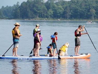 The End of the Leash team was ready for a good time as it used this large standup paddleboard for the first annual Doggy Paddle fundraiser for the Ontario SPCA Renfrew County Animal Care Centre at the Petawawa Point Aug. 21. End of the Leash also donated a SUP which was raffled off to raise funds towards the event.