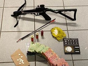 Chatham-Kent police seized approximately $1,500 worth of suspected methamphetamine, Percocet and LSD, as well as digital scales, a crossbow, ammunition and Canadian cash, in a drug bust in Dresden, Ont., on Wednesday, Aug. 18, 2021. (Chatham-Kent Police Service Photo)