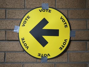 A sign directs voters to a polling station.