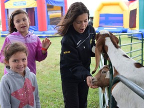 Kate, Sarah, and Julia Weiler enjoyed feeding the friendly goats at Little Track Petting Zoo at the Seaforth Fall Fair in 2019. The fair is returning this year after a one-year hiatus, and will be held Sept. 16-19. Dan Rolph