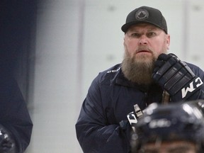 Stratford Warriors head coach Dave Williams -- and his magnificent beard -- listen to assistant Mike Graham draw up a play Saturday during training camp at the Rotary Complex.