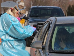 Sarah Milner, a registered nurse and executive director of the Central Lambton Family Health Team, administers COVID-19 tests in Forest during a one-day drive-thru clinic held in March. The health team, located in Petrolia, is adding two more family doctors.