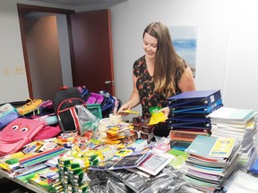 Brittany Burly, executive director of the United Way of Haldimand Norfolk, sorts through schools supplies during a previous edition of  Stuff the Bus program. The program is running again this year. Items can be donated until August 20. CONTRIBUTED PHOTO