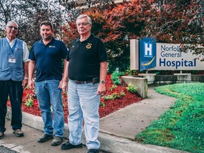 Norfolk General Hospital volunteer Doug Sibbett, from left, Dan Sinclar, project manager at Sinclair Homes, and Ron Keba, Simcoe Lions Club president, stand in front of the newly redone walkway at Norfolk General Hospital in Simcoe.
