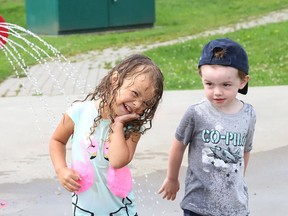 Ophelia Lepage, 3, left, and Cooper Annett, 2, cool off at the splash pad at the Kinsmen Sports Complex in Lively, Ont. on Monday August 9, 2021. John Lappa/Sudbury Star/Postmedia Network