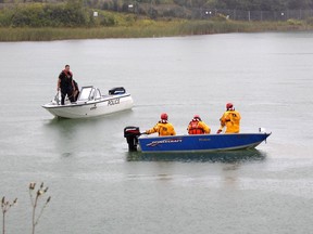 An Ontario Provincial Police marine unit along with a team from the Timmins Fire Department are seen conducting a search for a vehicle that went into Little Pearl Lake Friday afternoon. On Saturday, the Timmins Police Service reported the recovery of three bodies -- one adult and two children. 



RICHA BHOSALE/The Daily Press
