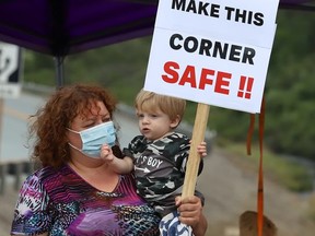 Tammy Amyotte and her grandson, Dominic, 1, take part in a protest with Onaping residents and supporters on Wednesday August 11, 2021. The group was protesting what they call a dangerous intersection on Highway 144 at Marina Road. John Lappa/Sudbury Star/Postmedia Network