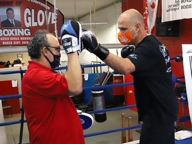 Gord Apolloni, left, of Top Glove Boxing Academy,  instructs Sudbury MPP Jamie West in one of a series of physical challenges against Owen Paquette, 16, a Quest for Gold athlete, at Top Glove Boxing Academy in Sudbury, Ont. on Friday August 13, 2021. The Quest for Gold program is designed for athletes to achieve their goals. Paquette's goal is to represent Canada in the 2024 Olympic games. John Lappa/Sudbury Star/Postmedia Network