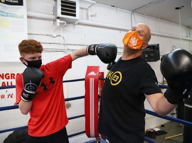 Sudbury MPP Jamie West and Owen Paquette, 16, a Quest for Gold athlete, ham it up after competing in a series of physical challenges at Top Glove Boxing Academy in Sudbury, Ont. on Friday August 13, 2021. The Quest for Gold program is designed for athletes to achieve their goals. Paquette's goal is to represent Canada in the 2024 Olympic games. John Lappa/Sudbury Star/Postmedia Network
