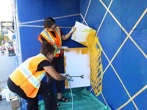Tammy Gaber, left, director of the McEwen School of Architecture, and Breana Chabot, sessional instructor at the school of architecture, work on a mural on Cedar Street in Sudbury, Ont. on Friday August 13, 2021, for the Up Here urban art and music festival.