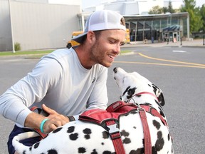 Skylar Roth-MacDonald of Calgary, along with his dog, Duke, attended a Meet and Greet for the 24-year-old runner in Sudbury, Ont. on Thursday August 19, 2021. Roth-MacDonald is running across the country to raise money for the Canadian Mental Health Association (CMHA). John Lappa/Sudbury Star/Postmedia Network