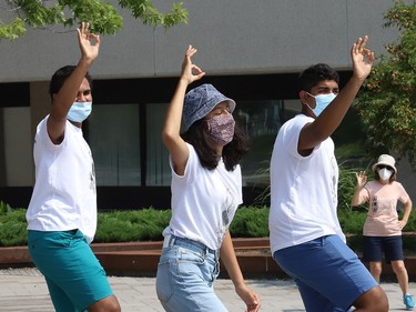 Ahmed Mohamed, left, Sophia Mathur and Arjun Shukla dance at a rally at Tom Davies Square in Sudbury, Ont. on Friday August 20, 2021. Fridays For Future Youth joined forces with Save Laurentian University Greenspace, Save Wolf Lake, and the Sudbury Chapter of the International Physicians for the Prevention of Nuclear War, to mark the third anniversary of Greta Thunberg's first school strike for the climate. John Lappa/Sudbury Star/Postmedia Network