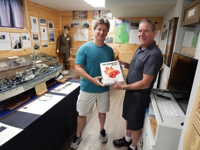 Local writer and researcher Tom Slater, author of The Sarnia War Remembrance Project (left) presents Plympton-Wyoming Historical Society President Gord MacKenzie (right) with a copy of his two-volume tome for use in the Plympton-Wyoming Museum. Carl Hnatyshyn/Sarnia This Week