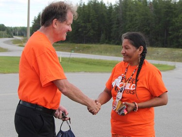 Patricia Ballantyne, was greeted by Timmins Mayor George Pirie as the Walk of Sorrow arrived in Timmins Sunday. Pirie accompanied the walkers from this point along on Highway 655 onto Hollinger Park.

RON GRECH/The Daily Press