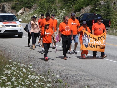 Passing motorists honked and offered expressions of support as participants in the Walk of Sorrow made their way south on Highway 655 in Timmins Sunday.

RON GRECH/The Daily Press