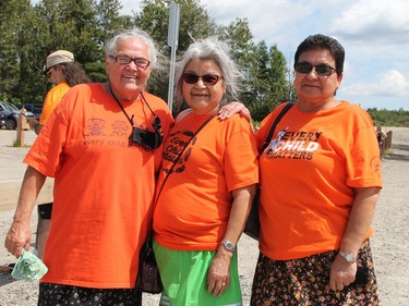 Among those waiting in the parking lot at the sliding hill across from Ross Avenue East to join the Walk of Sorrow when it came by were, from left, Cheryl Macumber, who did the opening prayer at the welcoming ceremony in Hollinger Park, Mushkegowuk Council Deputy Grand Chief Rebecca Friday and Irene Camillo, who helped to organize the event at the park.

RON GRECH/The Daily Press