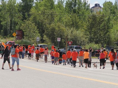 A large group of supporters waiting in the parking lot at the sliding hill across from Ross Avenue East to join the Walk of Sorrow when it came by.

RON GRECH/The Daily Press
