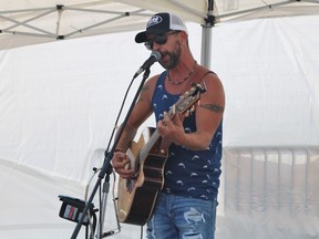 Eric Girard performs during Streetfest: Back To Life in downtown Timmins on Saturday. Hundreds of local residents flocked to the six-hour event, eager for the opportunity to once again listen to live mush while enjoying a sunny day in the heart of the community. See additional coverage on Page A3. ANDREW AUTIO/THE DAILY PRESS