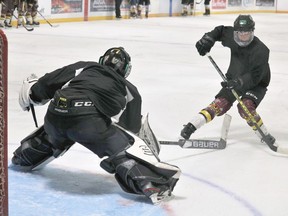 Goaltender Jayden Brassard attempts a poke check on forward Aiden Purificati on a penalty shot during the Timmins Rock's final training camp scrimmage on Friday in Porcupine. Purifcati was stopped on the play. Both players are expected to suit up for the Timmins Majors this season.