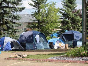 The tent encampment, formerly located in the parking lot of Rock Soup Greenhouse and Food Bank, relocated to a city-owned field next to the Walmart on Thursday, Aug. 26.