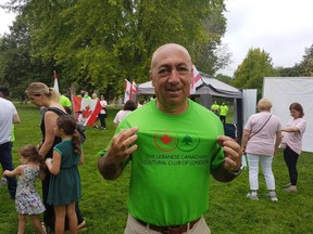Majed Fianni, head of the Lebanese Canadian Cultural Club of London, pauses during Sunday's Walk for Lebanon in a T-shirt the group is selling to help raise money for Lebanese people affected by last year's devastating explosion in Beirut's portlands. (Dan Brown/The London Free Press)