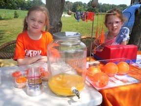 Josephine Jurenas, 7, on the left, was assisted at her Eden-area drink stand Saturday by best friend Mia Thorburn. Together, with the family yard sale, they raised more than $1,000 which will be donated to the Woodland Cultural Centre in Brantford. (Chris Abbott/Norfolk and Tillsonburg News)