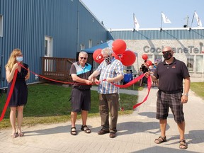 Mayor Denis Clement and Chief Executive Officer for CochraneTel Todd Collins cut the ribbon to usher in the next chapter in the service company's future. Holding the ribbon are Roxanne Desroches, Office Manager and Al Tremblay, Operations Manager.