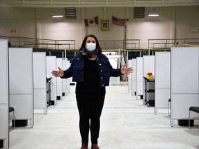 Jaime Fletcher, manager of the Southwestern Public Health COVID-19 vaccination task force, stands in front of the 36 vaccination stations on the arena surface at the St. Thomas-Elgin Memorial Arena. (Kathleen Saylors/Postmedia Network)