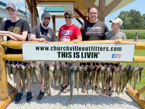 Garett Macdonald and his sons, his brother-in-law Chris Taylor and his son, show off their catches after their Churchville Outfitters charter. Churchville Outfitters