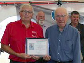 Bill Kemp accepting (left) his certificate of induction from MDHS President Garth Rudolph.
--Millet Museum