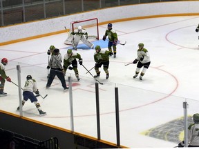 Team Green goaltender Dom DiVincentiis watches teammates vie for the puck off a faceoff in intrasquad action Wednesday at the North Bay Battalion's training camp. DiVincentiis backstopped a 2-1 victory over Team White.