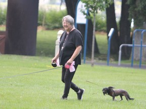 Debbie Cumming walks her dogs Sirie and Izzy at Clergue Park on Tuesday, Aug. 31, 2021 in Sault Ste. Marie, Ont. (BRIAN KELLY/THE SAULT STAR/POSTMEDIA NETWORK)